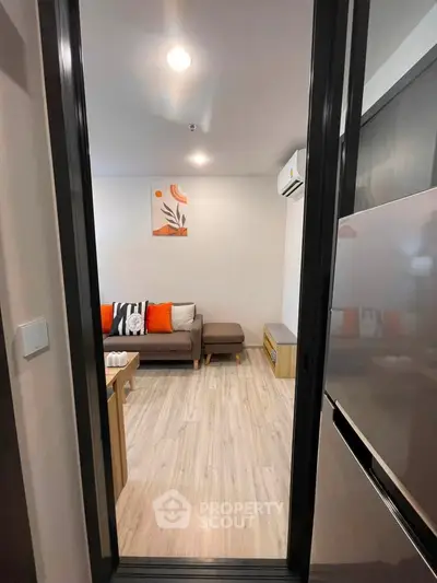 Modern living room with stylish decor and cozy seating in a contemporary apartment.