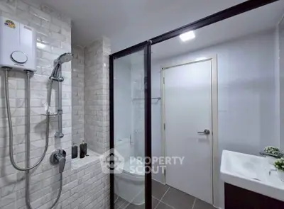 Modern bathroom with sleek shower and stylish tiles in contemporary apartment.