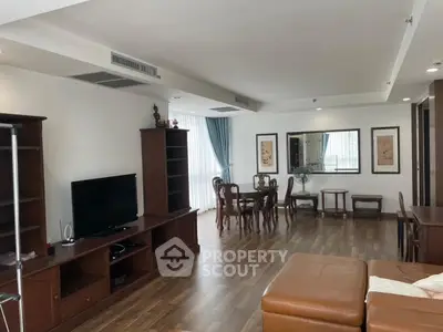 Spacious living room with wooden flooring and elegant furniture