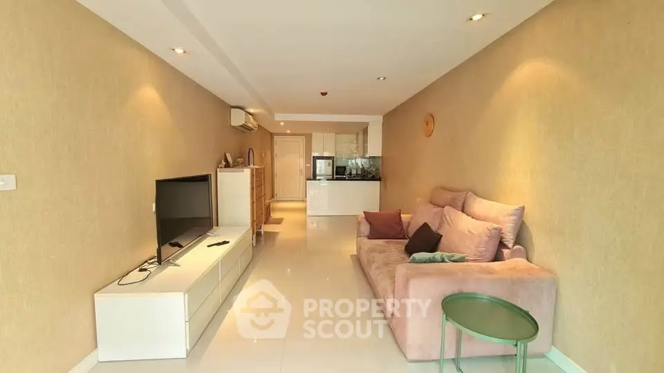 Spacious modern living room with cozy sofa and sleek TV unit in a stylish apartment.
