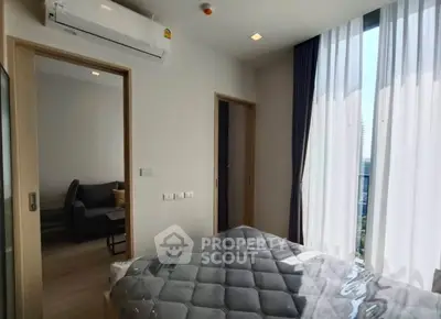 Modern bedroom with large window and air conditioning unit