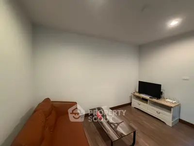 Cozy living room with brown sofa and modern TV setup