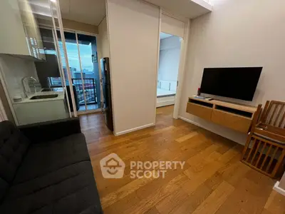 Modern apartment with open layout, hardwood floors, and city view balcony.