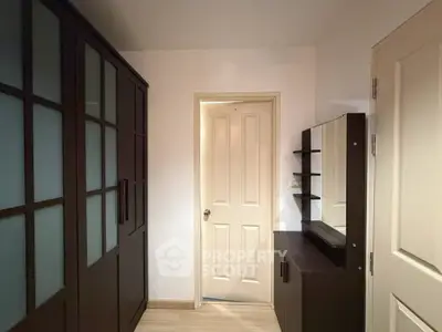Spacious storage room with modern dark wood cabinetry and sleek design.