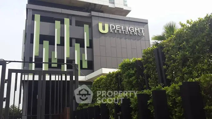 Modern apartment building with stylish facade and lush greenery