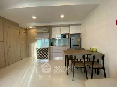 Modern kitchen and dining area with sleek design and ample storage space.