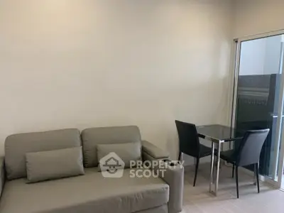 Modern living room with sleek sofa and dining area near balcony