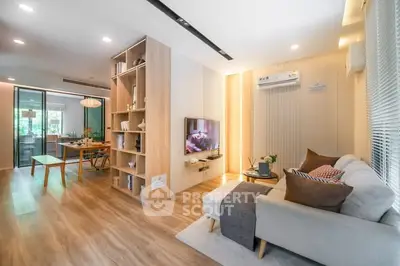 Modern open-plan living room with stylish decor and natural light