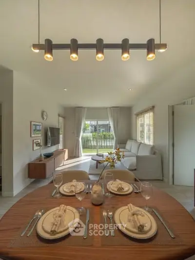 Elegant living room with modern dining area and stylish decor, perfect for entertaining guests.