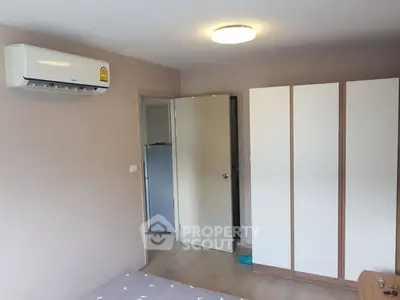 Cozy bedroom with air conditioning and modern wardrobe design.