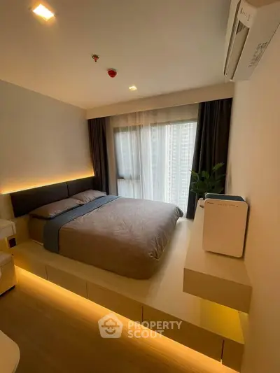 Modern bedroom with ambient lighting and city view, featuring sleek design and air purifier.