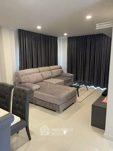 Modern living room with elegant gray sofa and sleek decor