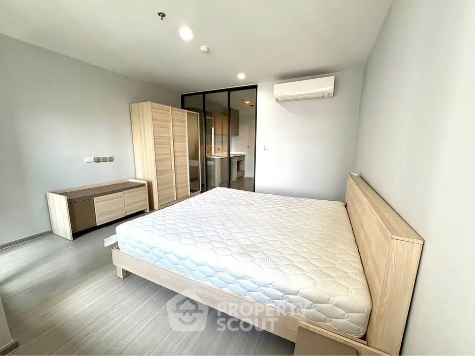 Spacious modern bedroom with minimalist design and ample natural light