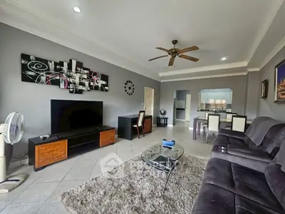 Spacious living room with modern decor and entertainment center