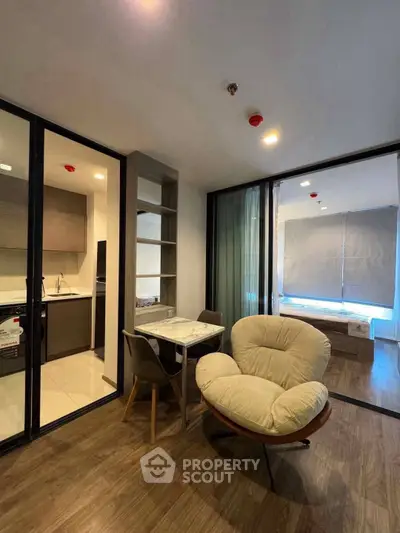 Modern apartment interior with open layout, featuring cozy living area and sleek kitchen design.