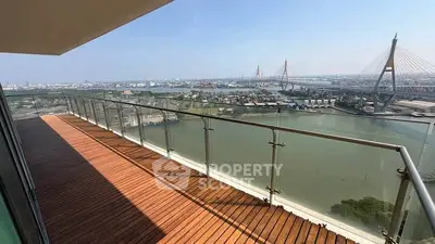 Stunning balcony with panoramic river and bridge view, perfect for relaxation and entertainment.