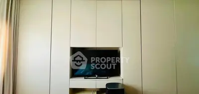 Modern minimalist living room with built-in TV cabinet and sleek design.