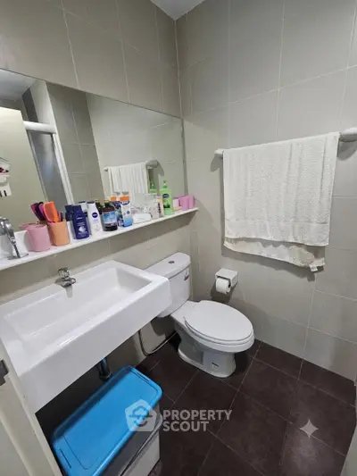 Modern bathroom with sleek fixtures and ample storage space.
