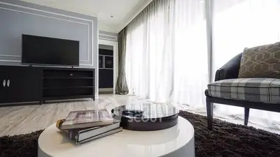 Modern living room with stylish decor and large windows for natural light.