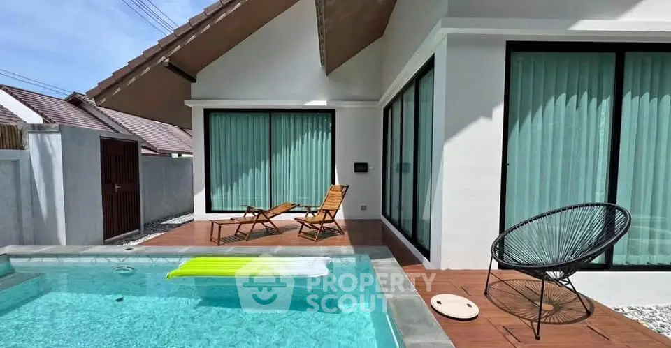 Charming villa exterior with private pool and stylish patio furniture, perfect for relaxation and leisure.