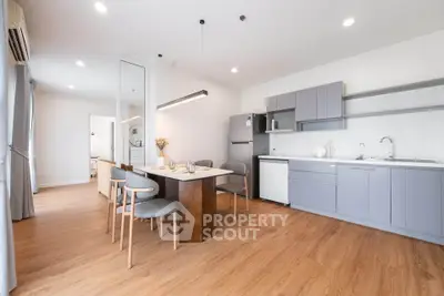 Modern kitchen with sleek cabinetry and dining area in open layout
