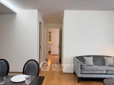 Modern living room with elegant dining area and cozy sofa, showcasing contemporary interior design.