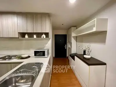 Modern kitchen with sleek cabinetry and built-in appliances in a stylish apartment.