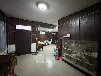Charming vintage interior with wooden walls and display cabinet, perfect for a cozy home atmosphere.