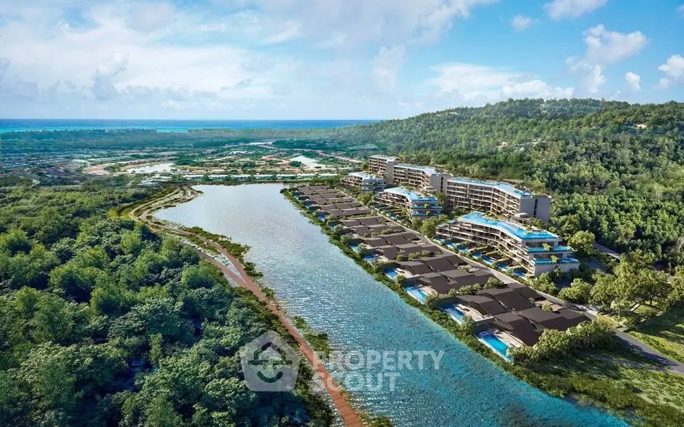 Stunning aerial view of luxury waterfront villas and apartments surrounded by lush greenery and serene waterway.