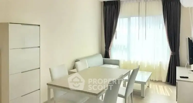 Bright and modern living room with elegant dining area and natural light.