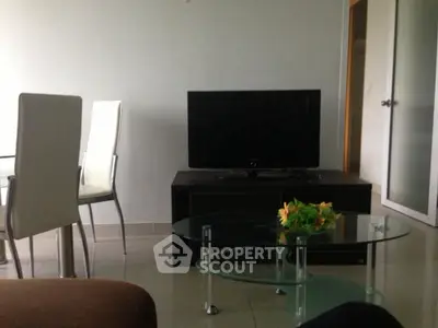 Modern living room with sleek furniture and flat-screen TV, perfect for relaxation and entertainment.