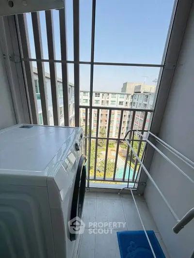 Charming balcony with washing machine and stunning city view, perfect for urban living.