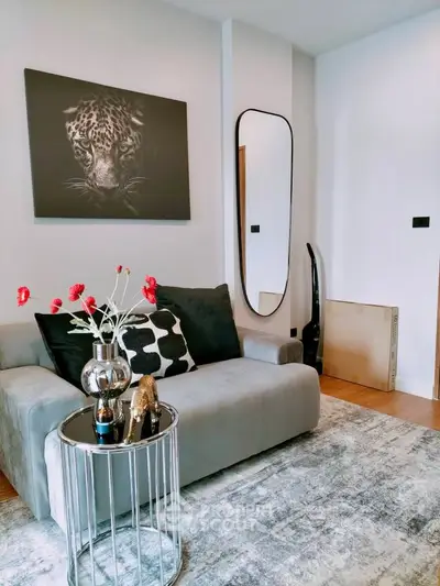 Stylish living room with modern decor and elegant furniture, featuring a chic wall art and cozy seating area.