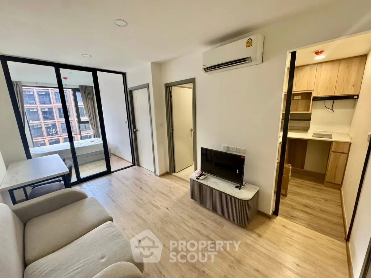 Modern apartment living room with open kitchen and natural light