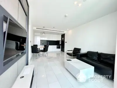 Modern living room with sleek black and white decor, open layout, and stylish furniture.