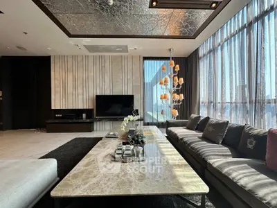 Luxurious modern living room with elegant decor and large windows offering stunning views.