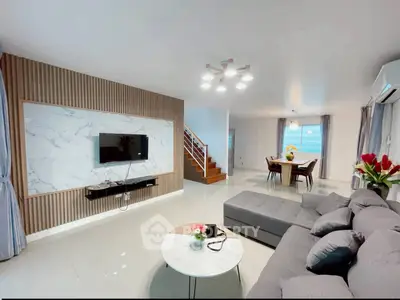 Modern living room with stylish decor and open dining area