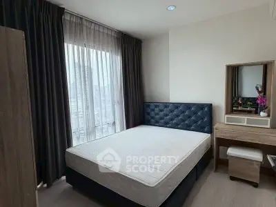 Modern bedroom with city view, featuring a stylish bed and elegant furniture.