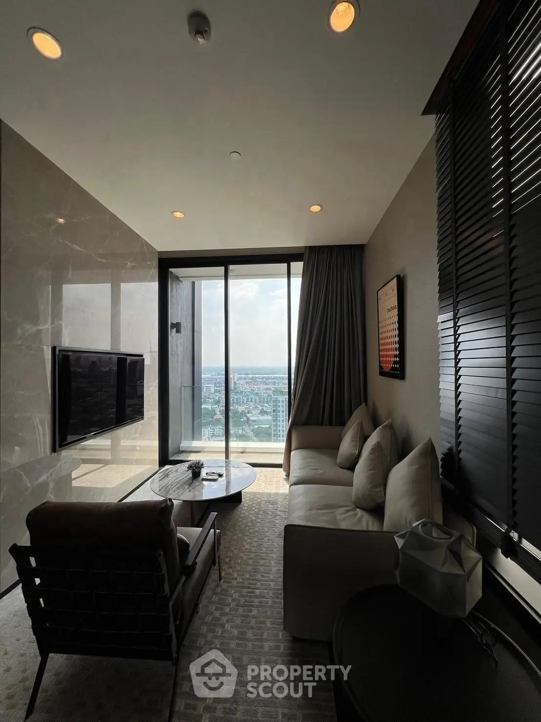 Luxurious living room with stunning city view and modern furnishings.