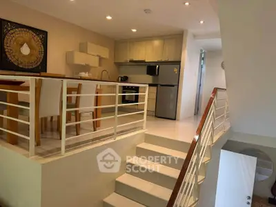 Modern kitchen with open layout and dining area in stylish apartment