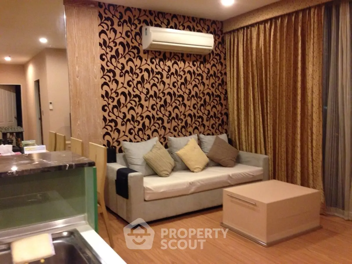 Stylish living room with modern decor and air conditioning in a cozy apartment.