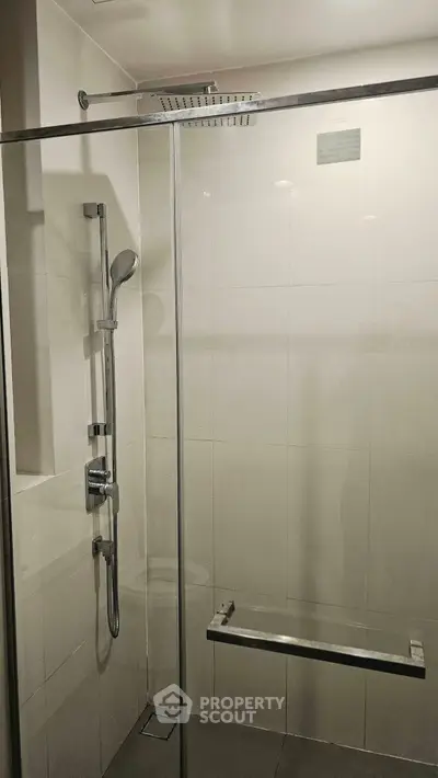 Modern bathroom with glass shower enclosure and sleek fixtures