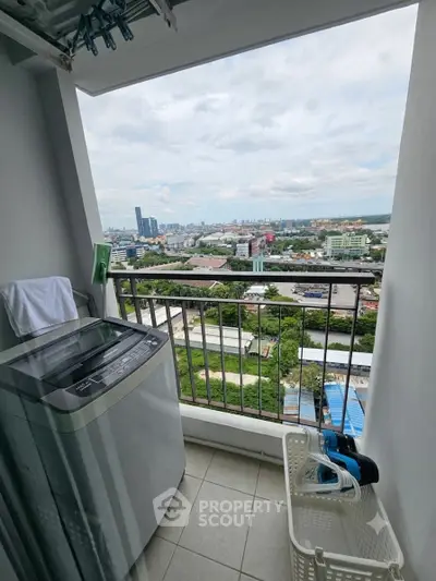 High-rise balcony with washing machine and panoramic city view