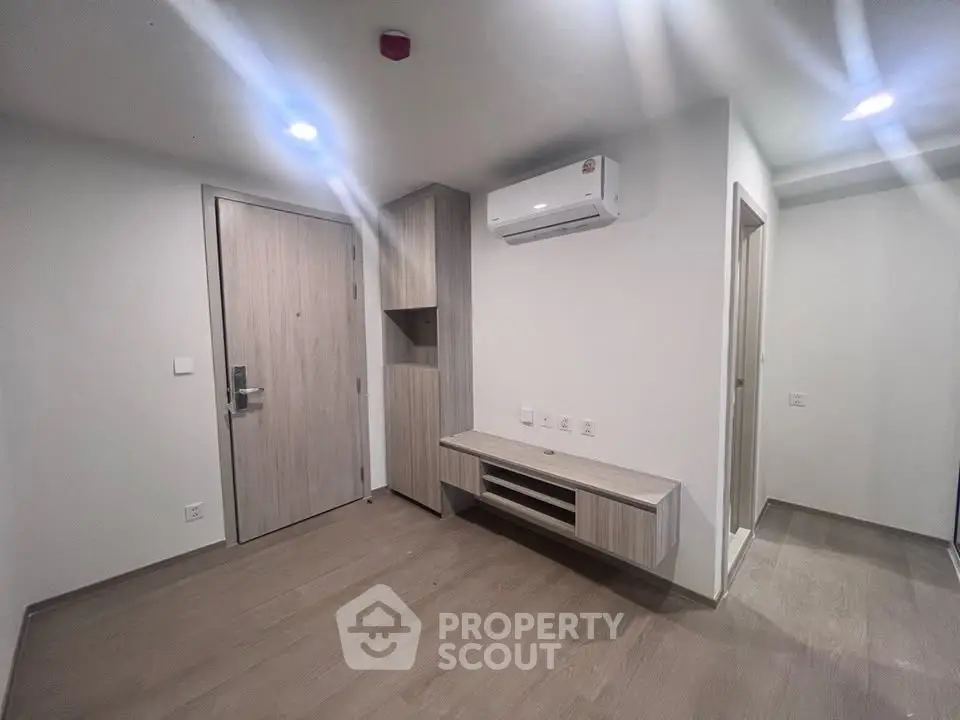 Modern minimalist interior with air conditioning and wooden flooring, perfect for a cozy living space.