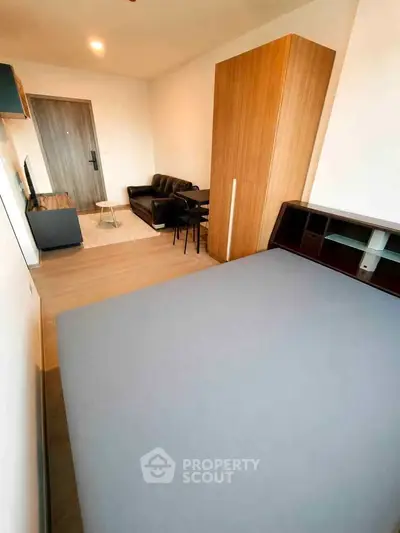 Modern studio apartment with cozy living area and stylish furniture