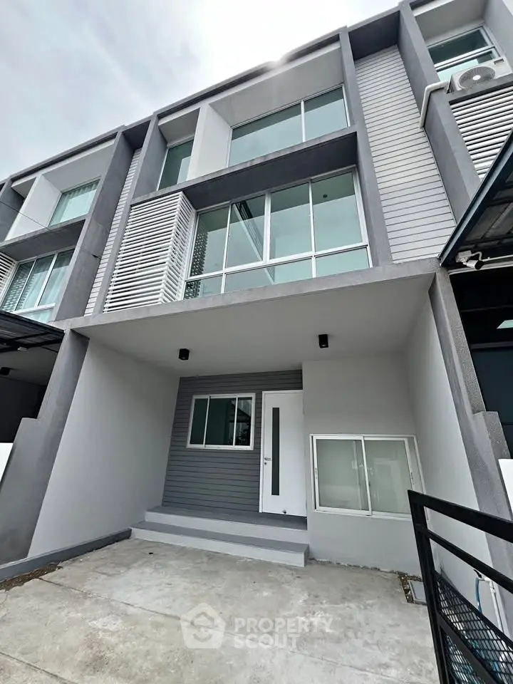 Modern townhouse exterior with sleek design and large windows