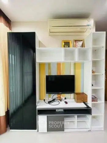 Modern living room with sleek entertainment unit and air conditioning