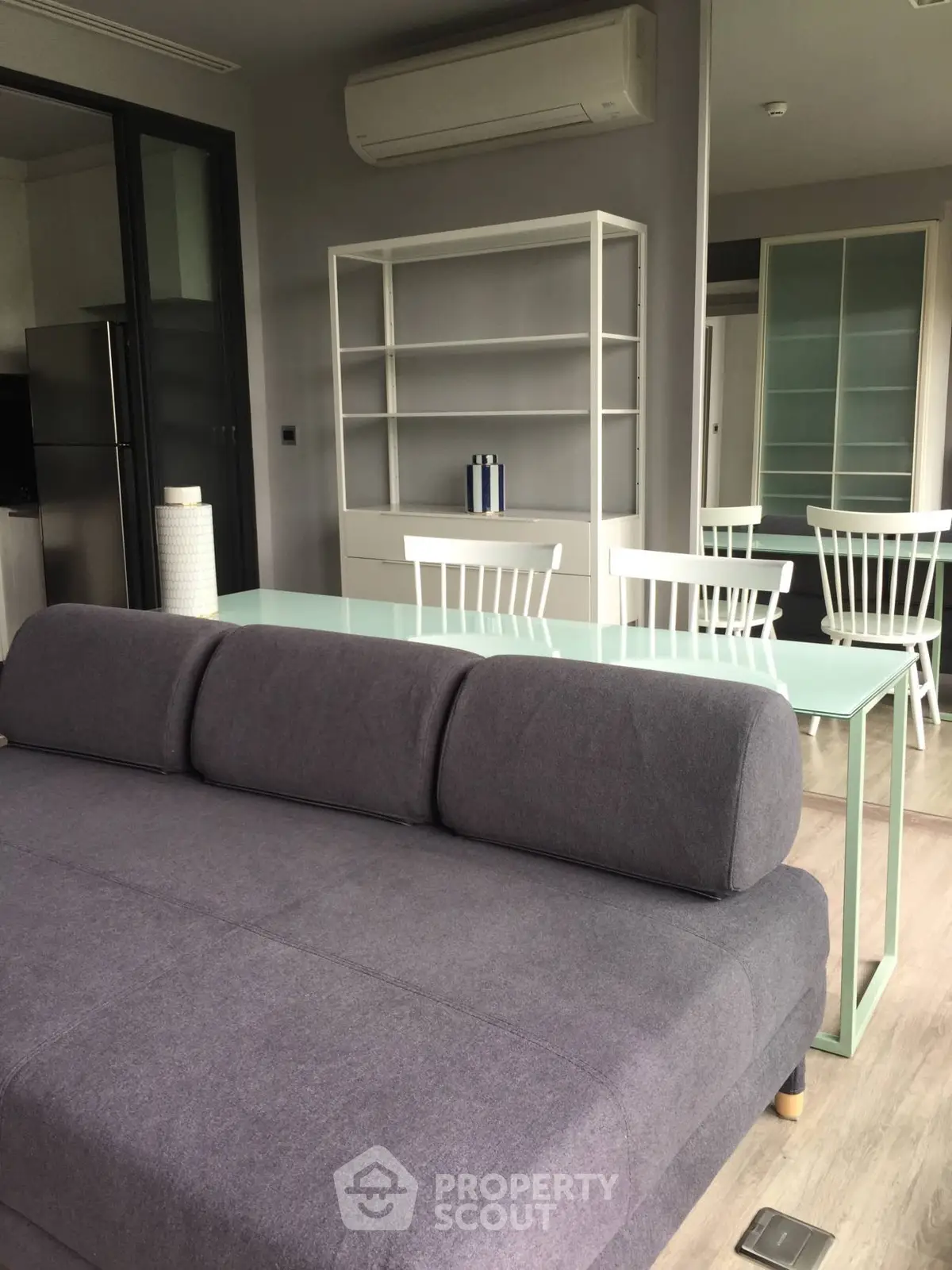 Modern living room with sleek furniture and air conditioning unit, perfect for comfort and style.