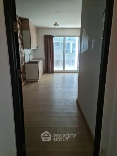 Spacious apartment with open kitchen and large windows for natural light.