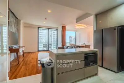 Luxurious open-plan kitchen and living room with modern appliances and stunning city view.
